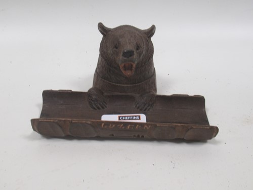 Lot 104 - A Black Forest inkwell with carved wood flip...