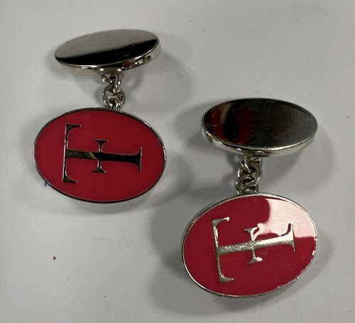 Lot 303 - Theo Fennell - A silver keyring and a pair of silver and enamel cuff links
