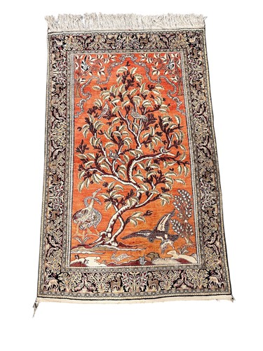 Lot 808 - A silk rug with tree of life on apricot ground, late 20th century