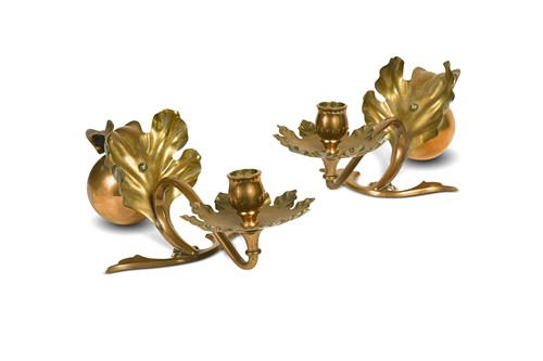 Lot 110 - Attributed to W.A.S. Benson, a pair of Arts & Crafts brass and copper ball and flower candlesticks
