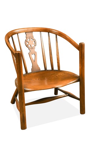 Lot 193 - An Arts & Crafts style low seated ash and elm star-back Windsor-type elbow chair