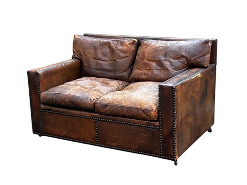 Lot 674 - A studded brown leather two-seat sofa, 82.5 x...