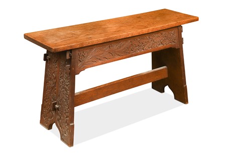 Lot 190 - An Arts & Crafts carved oak bench
