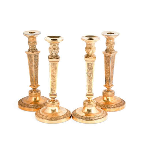 Lot 490 - A set of four gilt metal classical style candlesticks, 19th century