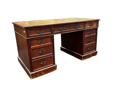 Lot 742 - An Edwardian pedestal desk, green inset...
