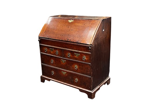 Lot 433 - An oak slope front bureau, 18th century