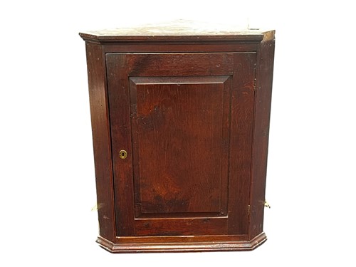 Lot 625 - An 18th century oak corner cupboard, with...