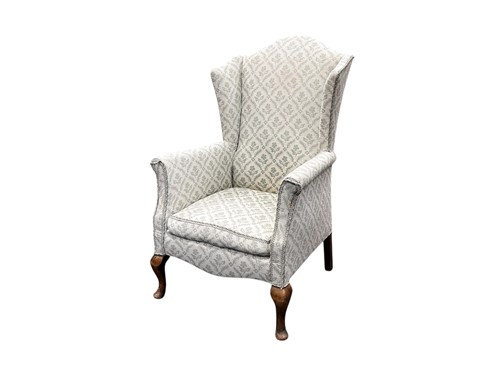 Lot 702 - A small Queen Anne style wingback armchair, on...