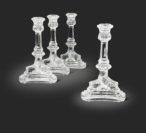 Lot 3 - Tiffany & Co., a group of four polished glass 'dolphin' candlesticks