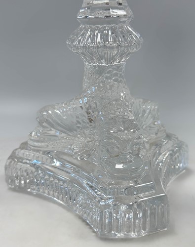 Lot 3 - Tiffany & Co., a group of four polished glass 'dolphin' candlesticks