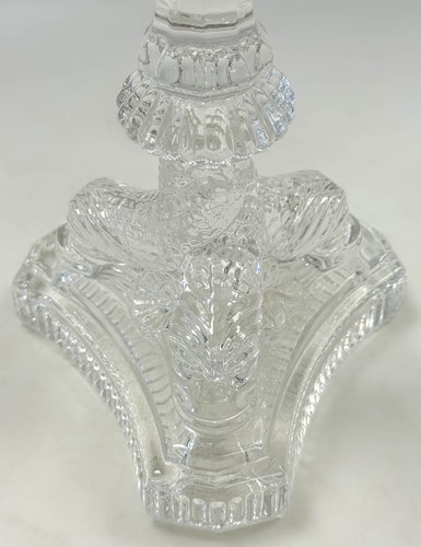 Lot 3 - Tiffany & Co., a group of four polished glass 'dolphin' candlesticks