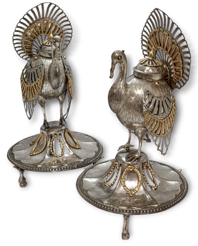 Lot 384 - A pair of Peruvian metalwares parcel gilt turkey censors