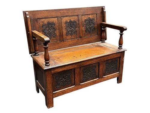 Lot 635 - A 20th century oak monk's bench, the lozenge...