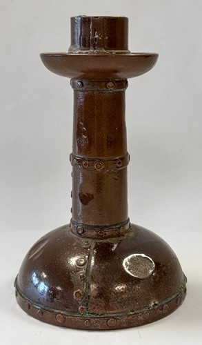 Lot 23 - An unusual Doulton Lambeth model of a young child perched upon a rock