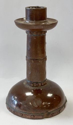 Lot 23 - An unusual Doulton Lambeth model of a young child perched upon a rock
