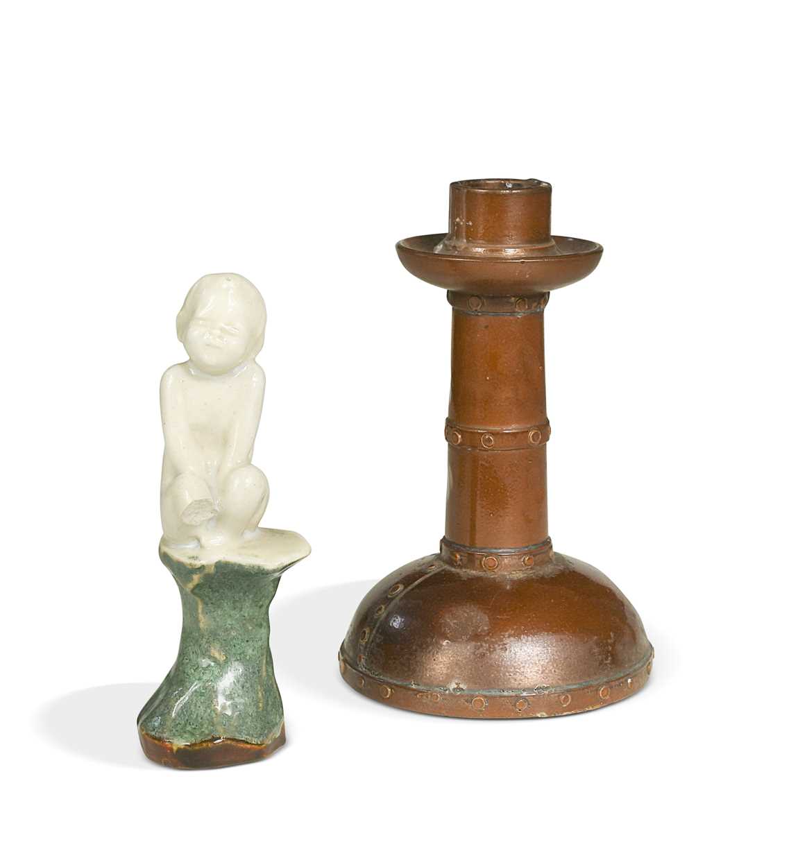 Lot 23 - An unusual Doulton Lambeth model of a young child perched upon a rock