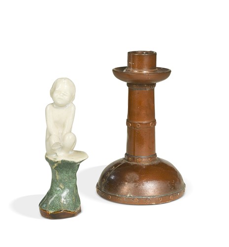 Lot 23 - An unusual Doulton Lambeth model of a young child perched upon a rock