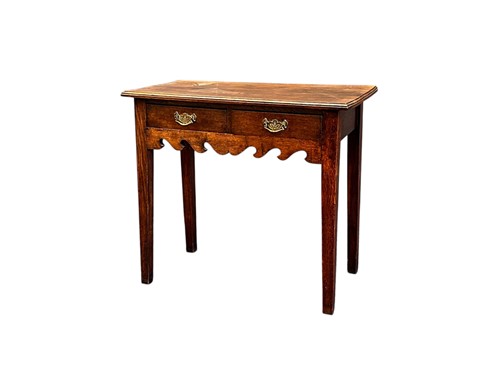 Lot 627 - A George III style oak side table, with two...