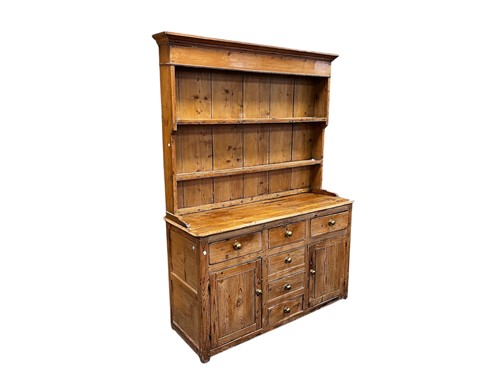 Lot 645 - A 19th century pine dresser with open plate...