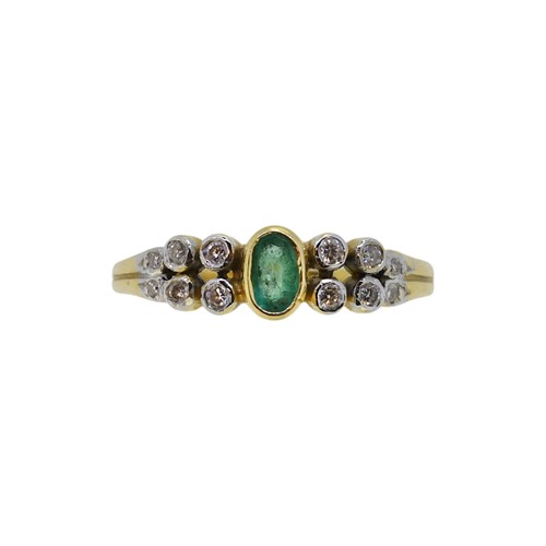 Lot 65 - An 18ct gold emerald and diamond ring