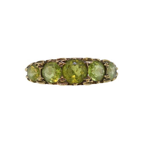 Lot 28 - A five stone peridot ring