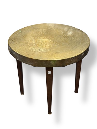 Lot 695 - A brass top occasional table embossed with...