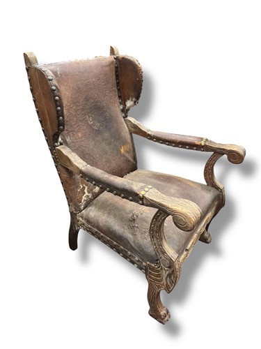 Lot 700 - A pair of leather distressed wingback...