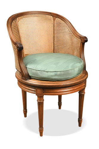 Lot 480 - A Louis XVI style caned swivel action bergere chair, circa 1900