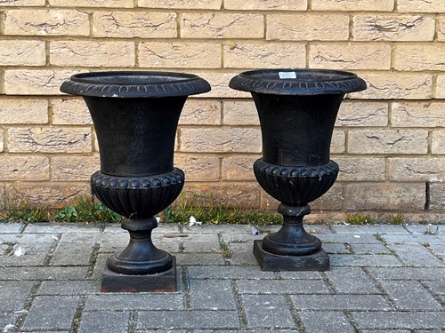 Lot 787 - A pair of black painted cast iron campana...