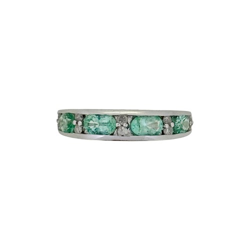 Lot 25 - A 9ct gold green beryl and diamond half hoop style ring