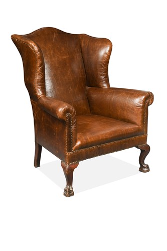 Lot 338 - A George III style leather wing back armchair