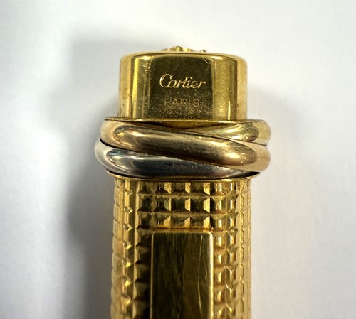 Lot 322 - Cartier - A 'Les Must de Cartier Trinity' gold-plated rollerball pen case