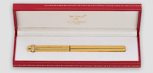 Lot 322 - Cartier - A 'Les Must de Cartier Trinity' gold-plated rollerball pen case