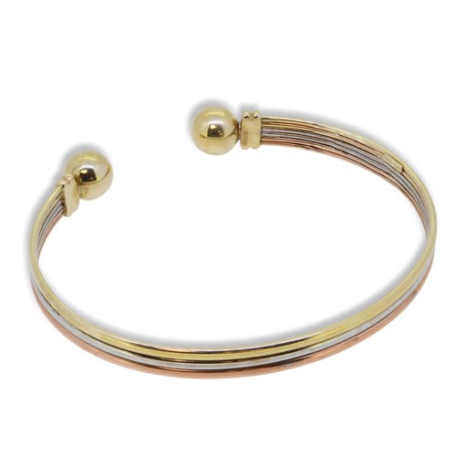 Lot 78 - A 9ct three colour gold torc bangle
