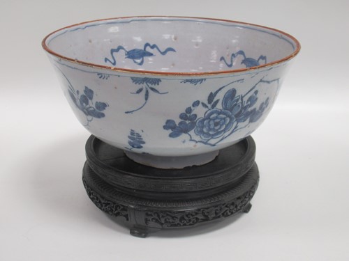 Lot 20 - An 18th century Delft blue and white bowl, on...