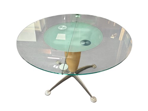 Lot 554 - A modern glass and chrome extending dining...