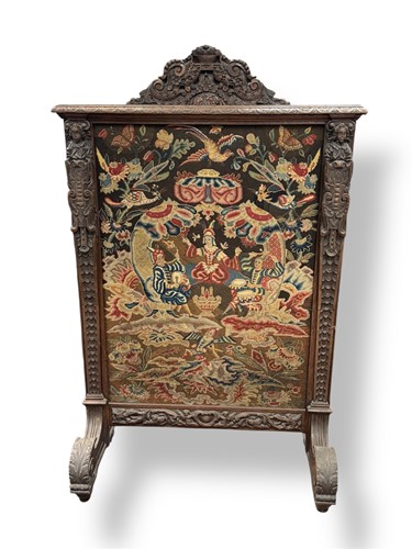 Lot 535 - A carved oak screen with needlework panel,...