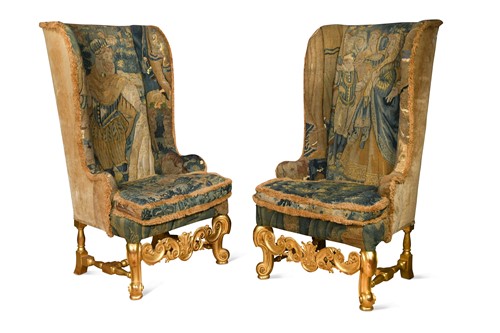 Lot A pair of Carolean-style carved giltwood wing back armchairs, 19th/20th century