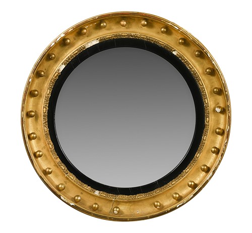Lot 556 - A large Regency convex wall mirror