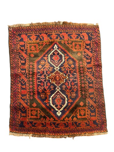 Lot 714 - A vintage Beluchi rug, the central elongated...