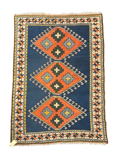 Lot 711 - A Kazak style rug, the navy blue ground with...