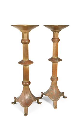 Lot 575 - A pair of patinated copper candlesticks, circa 1900
