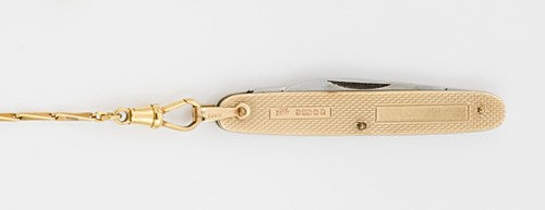Lot 334 - A 20th century 9ct gold folding penknife with accompanying chain