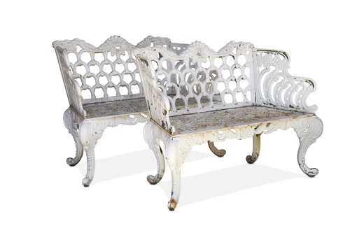Lot 603 - A pair of Rococo style cast iron white painted garden benches, late 19th century