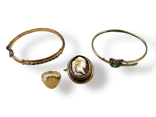Lot 313 - A cameo brooch and two bangles, tested as 9ct,...