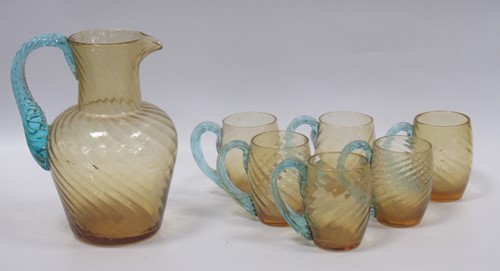 Lot 8 - A hand blown swirled amber glass jug or...