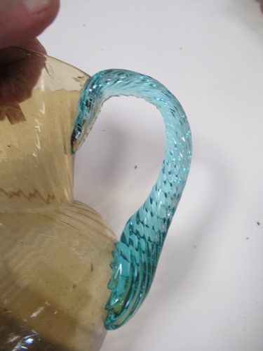 Lot 8 - A hand blown swirled amber glass jug or...