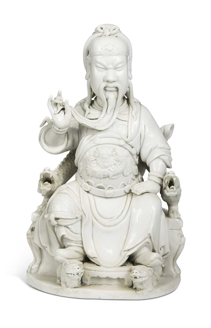 Lot 48 - A Dehua seated figure of Guandi, Daoist God of War, mark of He Chaozong