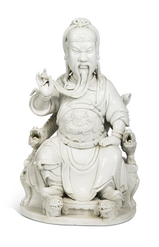 Lot 48 - A Dehua seated figure of Guandi, Daoist God of War, mark of He Chaozong