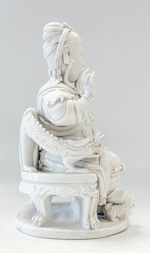 Lot 48 - A Dehua seated figure of Guandi, Daoist God of War, mark of He Chaozong